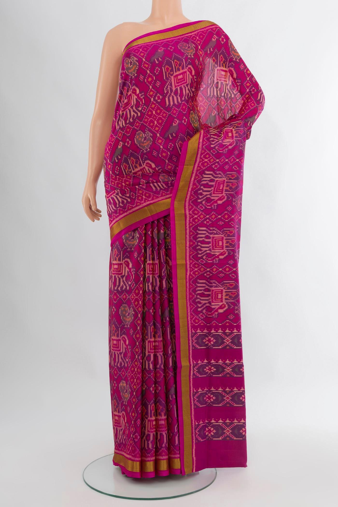 Magenta Rajkot Patola Silk Saree with Pure Ikat on the body and Zari Border.  displayed on a mannequin