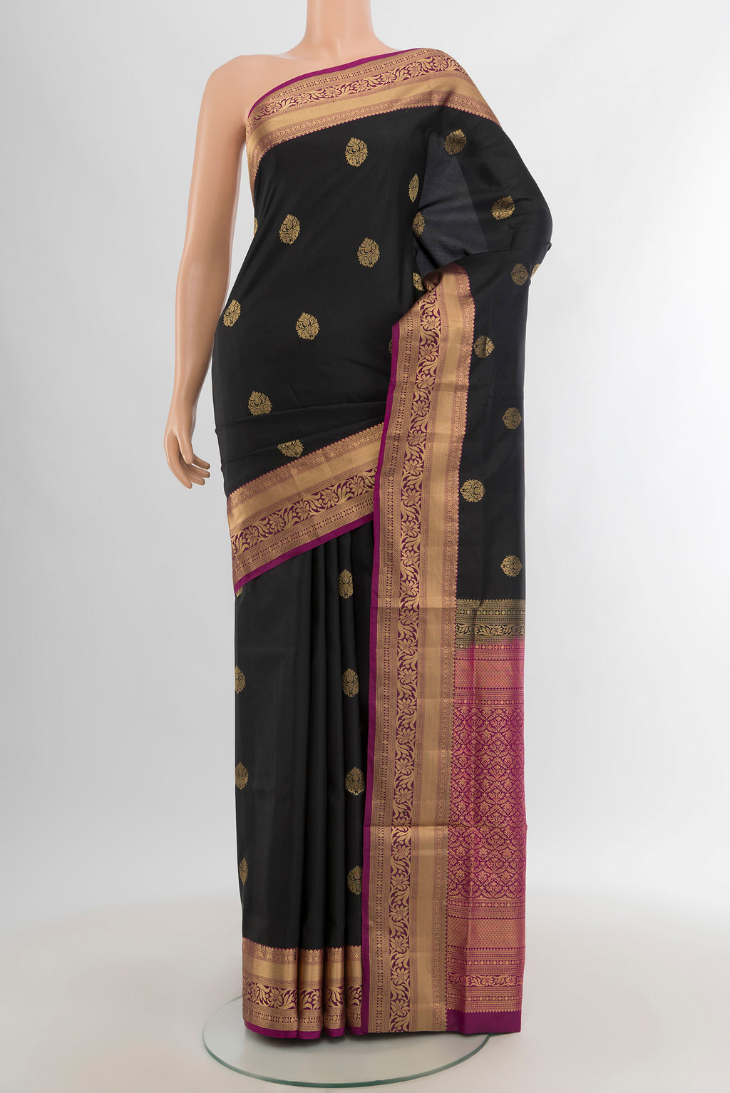 Black Soft Silk Saree with Zari Butta on the body and Zari Border.  displayed on a mannequin
