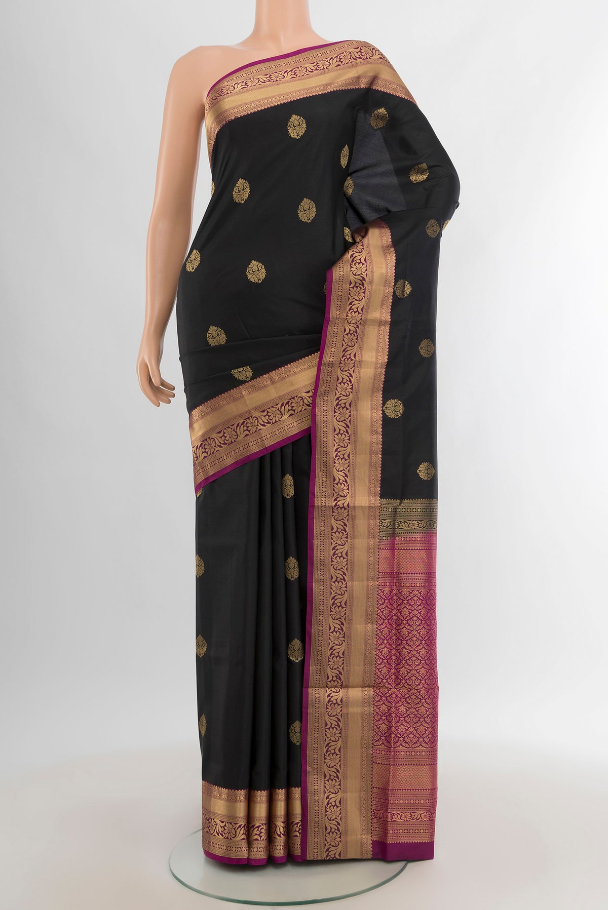 Black Soft Silk Saree with Zari Butta on the body and Zari Border.  displayed on a mannequin