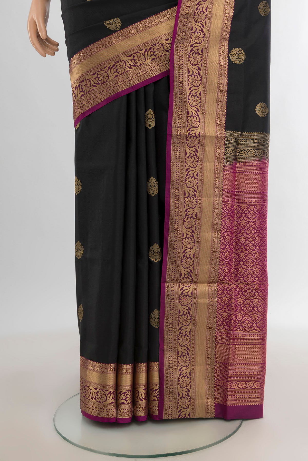 Pleats and pallu of Black Soft Silk Saree with Zari Butta on the body and Zari Border. 