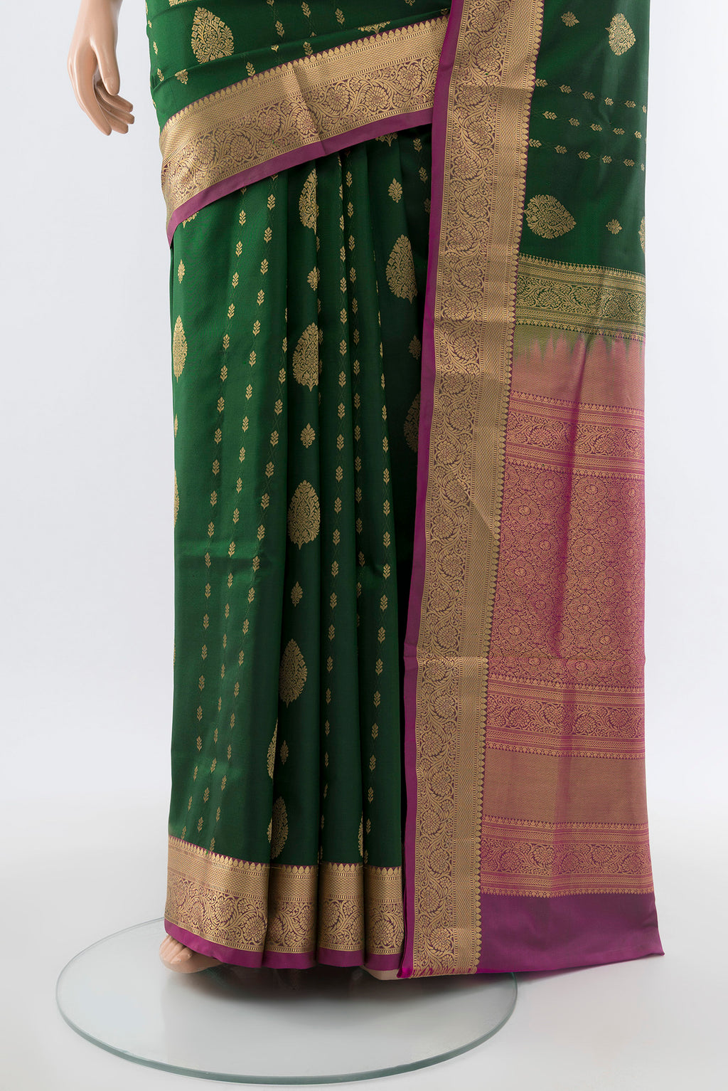 Pleats and pallu of Bottle Green Soft Silk Saree with Zari Butta on the body and Silk Border. 
