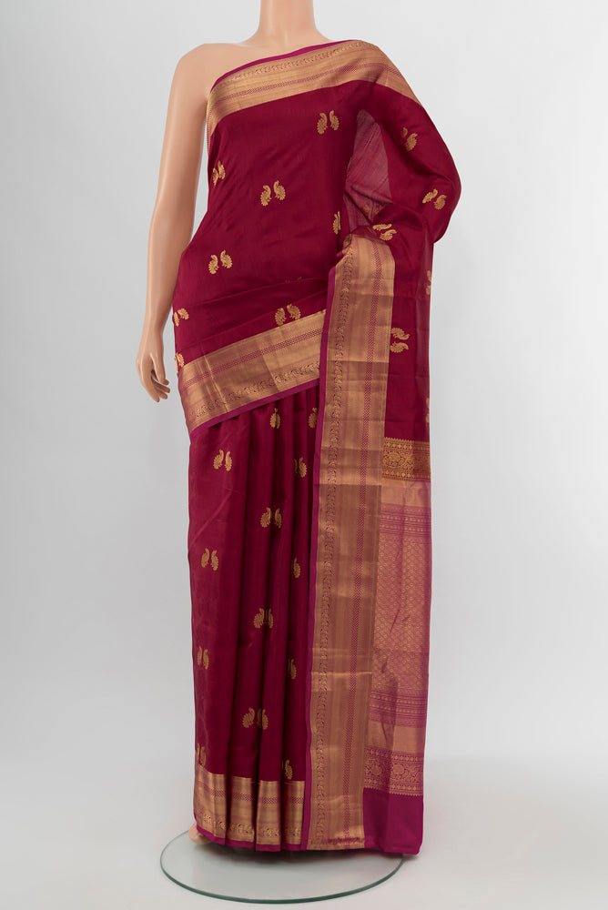 Maroon Soft Silk Saree with Zari Butta on the body and Silk Border.  displayed on a mannequin