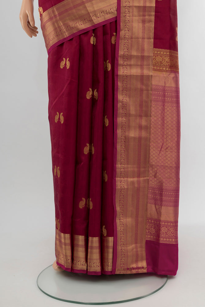 Pleats and pallu of Maroon Soft Silk Saree with Zari Butta on the body and Silk Border. 