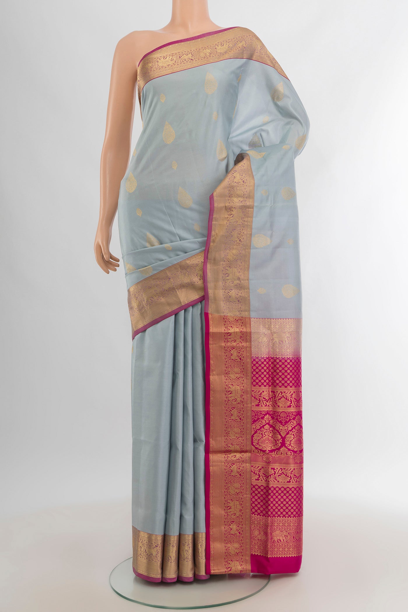 Grey Soft Silk Saree with Zari Butta on the body and Zari Border.  displayed on a mannequin