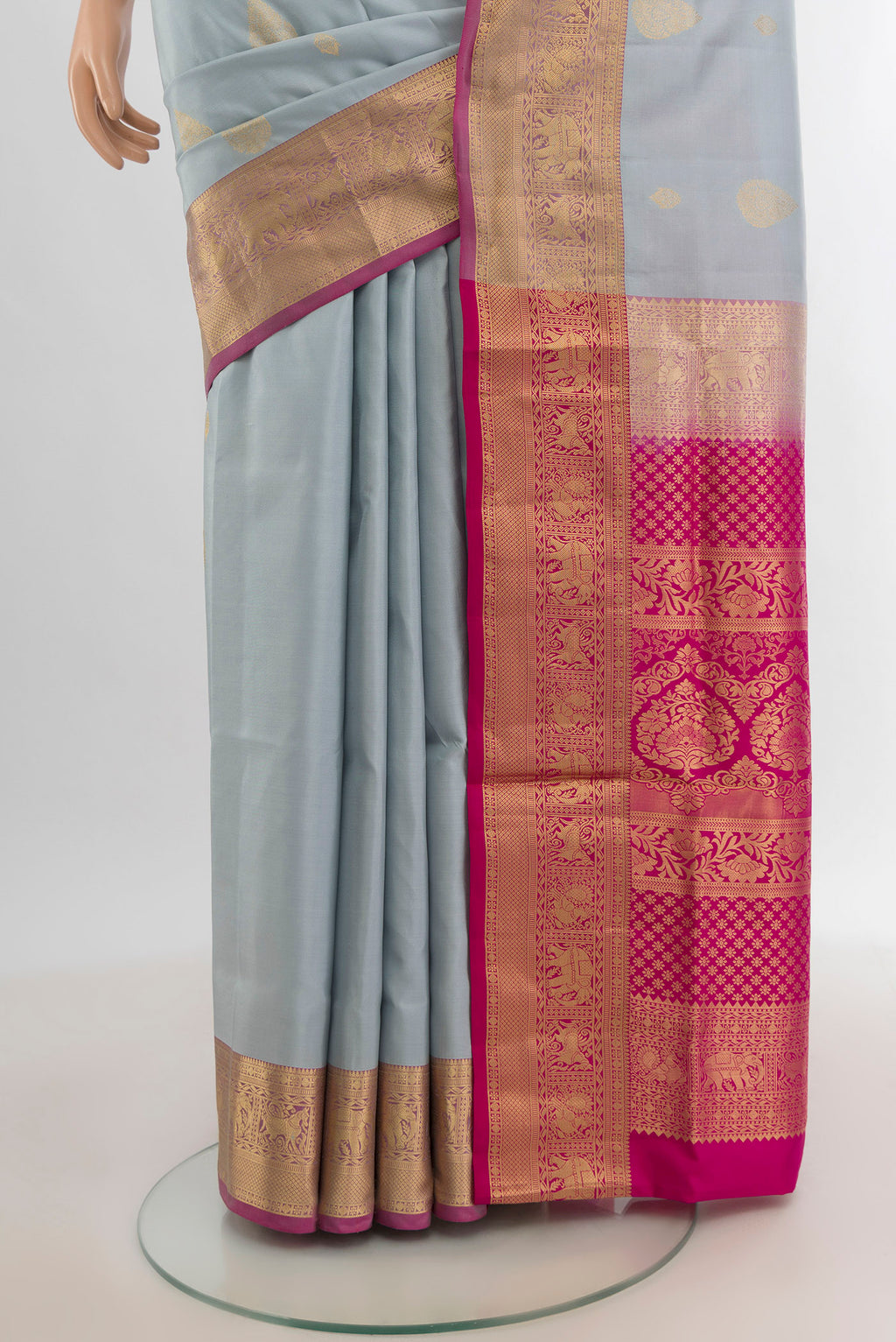 Pleats and pallu of Grey Soft Silk Saree with Zari Butta on the body and Zari Border. 