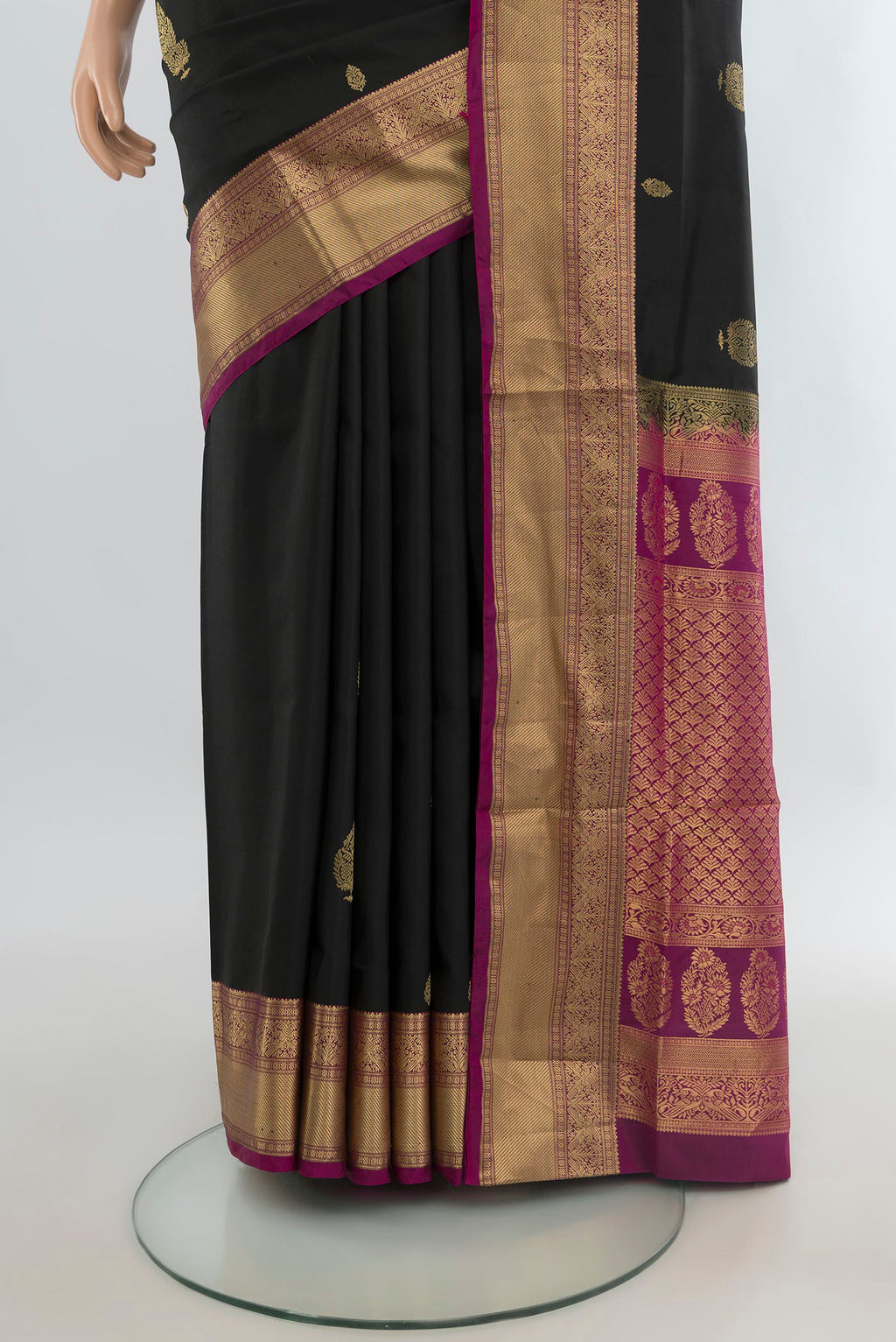 Pleats and pallu of Pure Silk Black Soft Saree with Zari Butta on the body and Zari Border. 