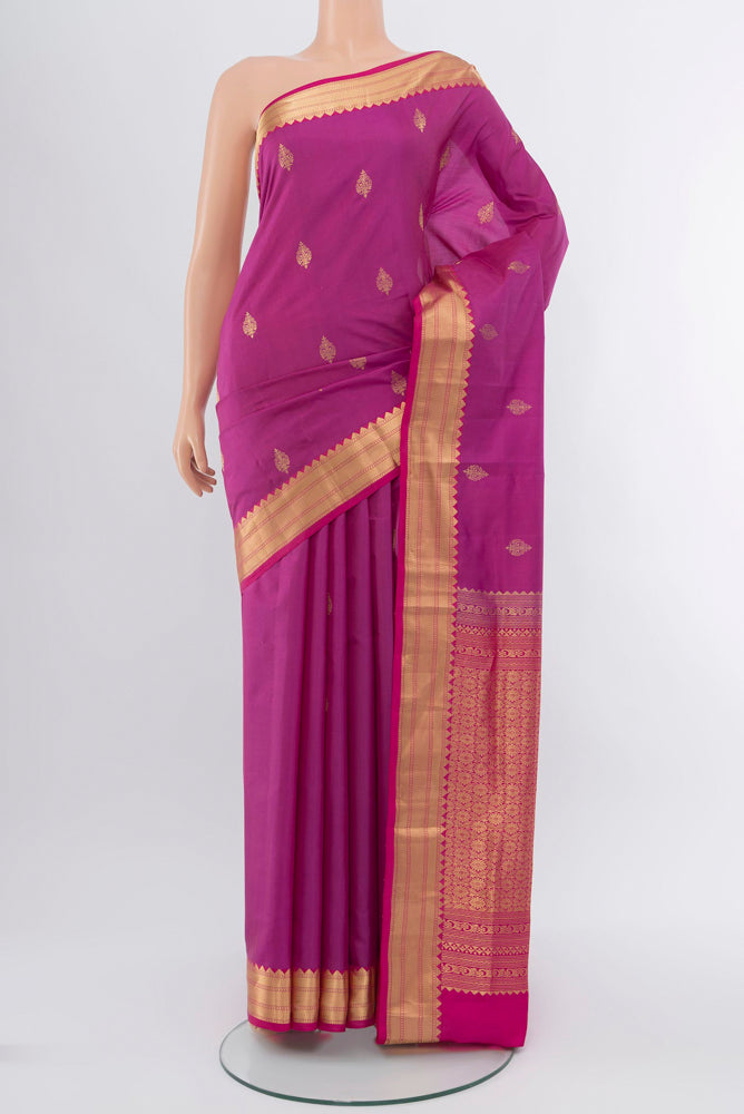 Purple Kanchipuram Silk Saree with Zari Brocade on the body and Silk Border.  displayed on a mannequin