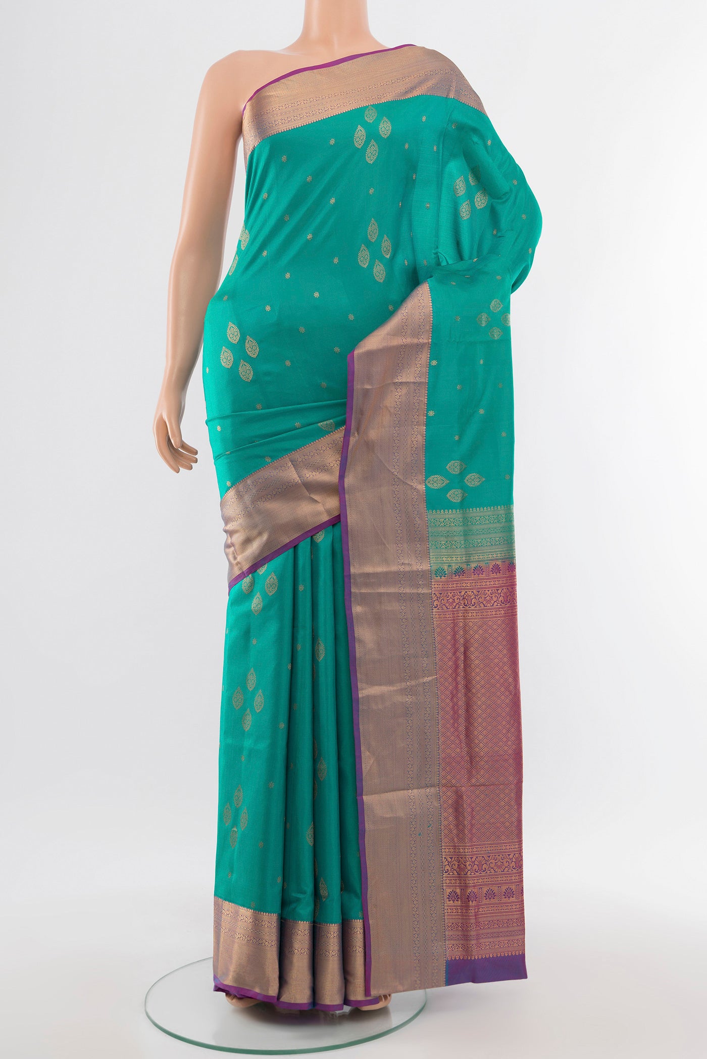 Light Blue Soft Silk Saree with Zari Butta on the body and Silk Border.  displayed on a mannequin