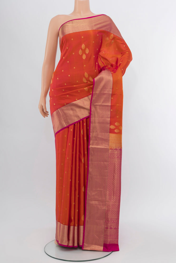 Peach Soft Silk Saree with Zari Butta on the body and Silk Border.  displayed on a mannequin