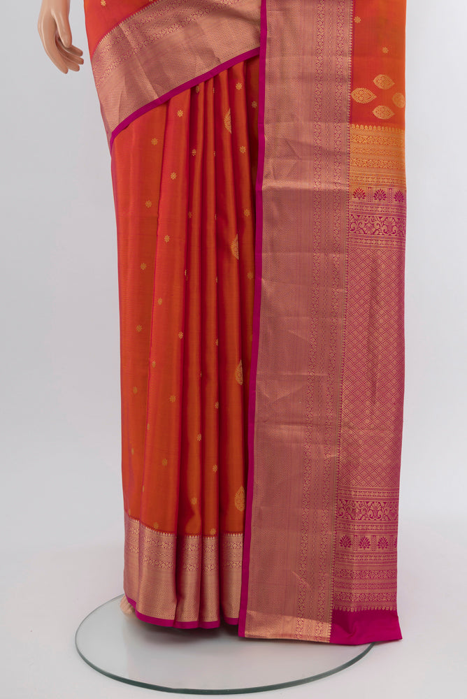 Pleats and pallu of Peach Soft Silk Saree with Zari Butta on the body and Silk Border. 