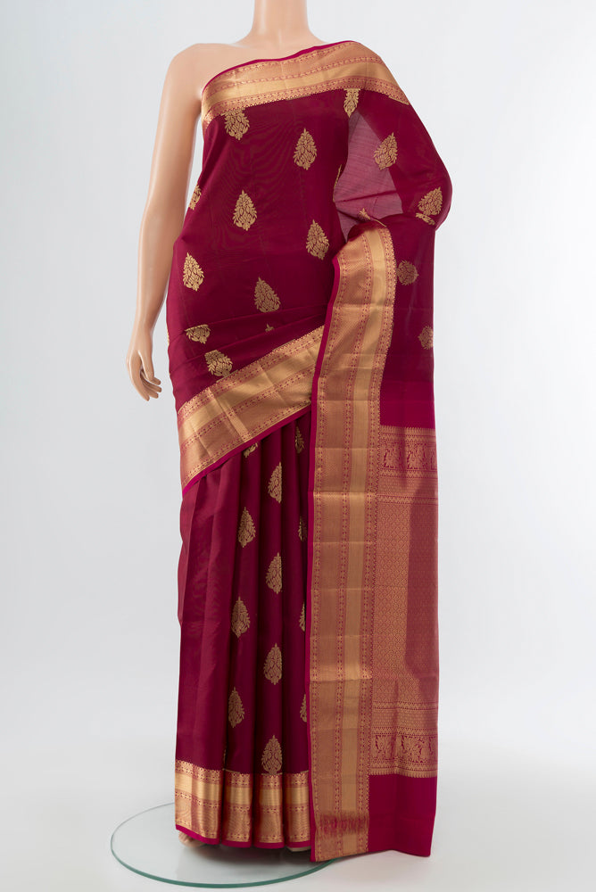 Maroon Soft Silk Saree with Zari Brocade on the body and Silk Border.  displayed on a mannequin