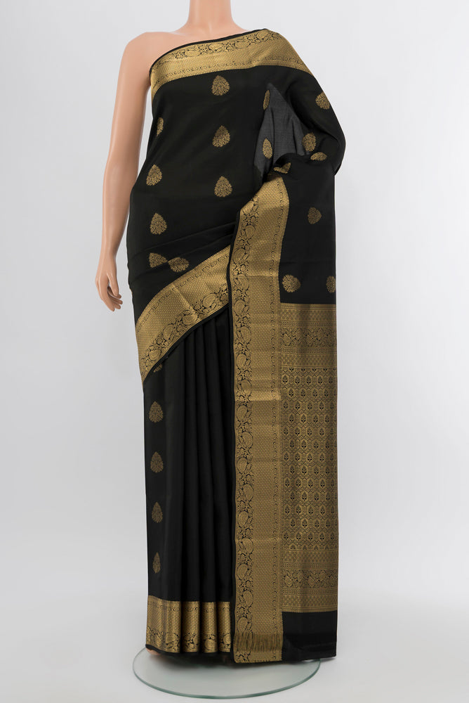 Black Soft Silk Saree with Zari Butta on the body and Silk Border.  displayed on a mannequin