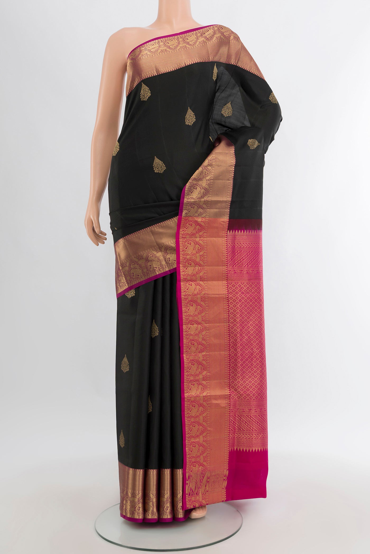 Black Soft Silk Saree with Zari Butta on the body and Zari Border.  displayed on a mannequin