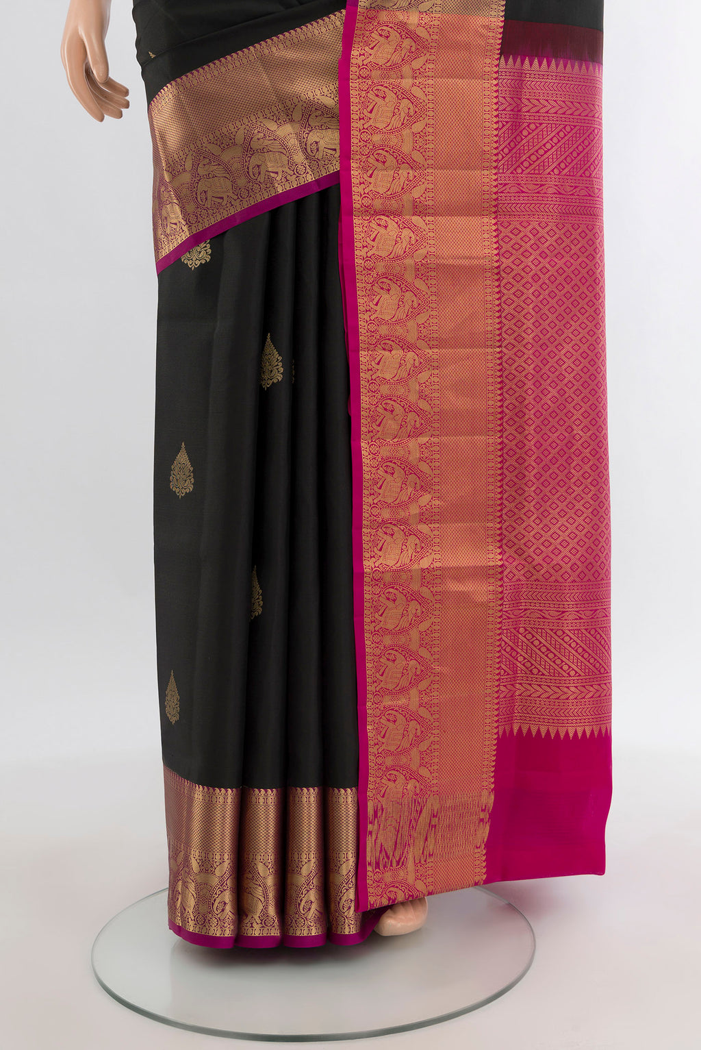 Pleats and pallu of Black Soft Silk Saree with Zari Butta on the body and Zari Border. 