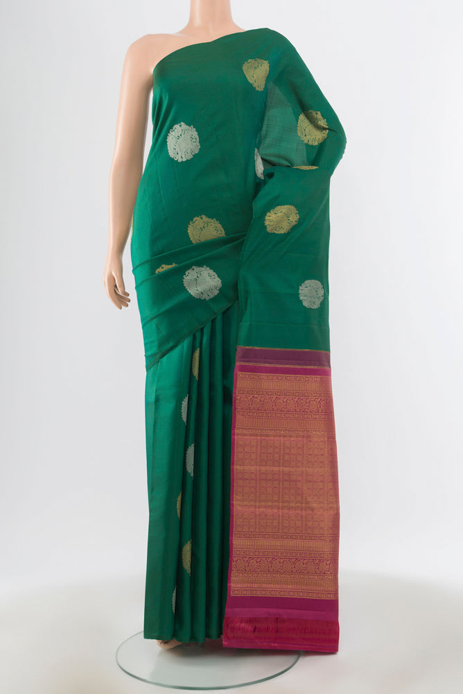 Peacock Blue Kanchipuram Silk Saree with Zari Brocade on the body and Silk Border.  displayed on a mannequin