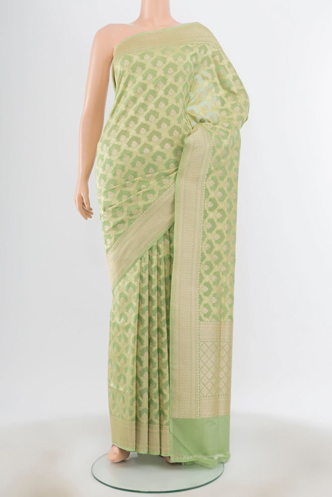 Pista Green Banarasi Silk Saree with Zari Butta on the body and Silk Border.  displayed on a mannequin