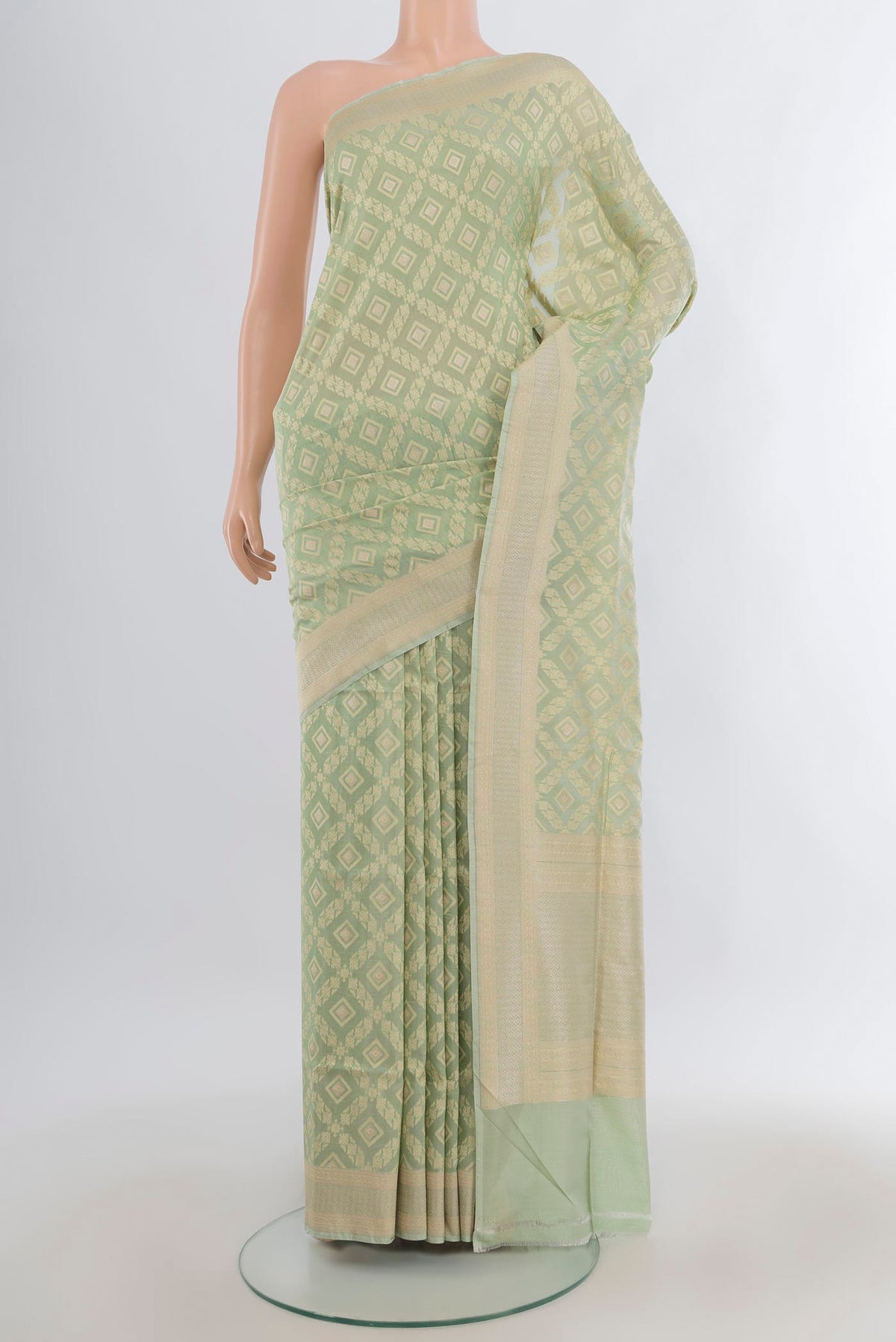 Pure Silk Pista Green Banarasi Saree with Zari And Thread Butta on the body and Zari Border.  displayed on a mannequin