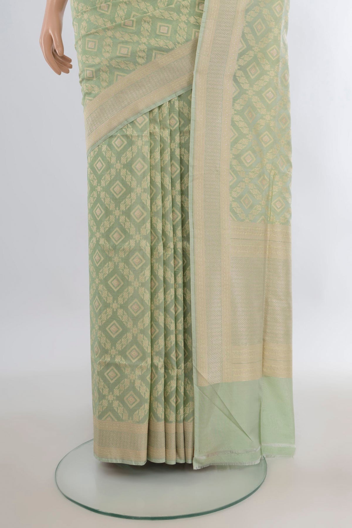 Pleats and pallu of Pure Silk Pista Green Banarasi Saree with Zari And Thread Butta on the body and Zari Border. 
