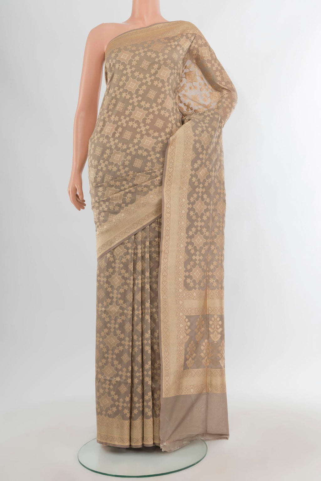 Grey Banarasi Silk Saree with Zari Butta on the body and Zari Border.  displayed on a mannequin