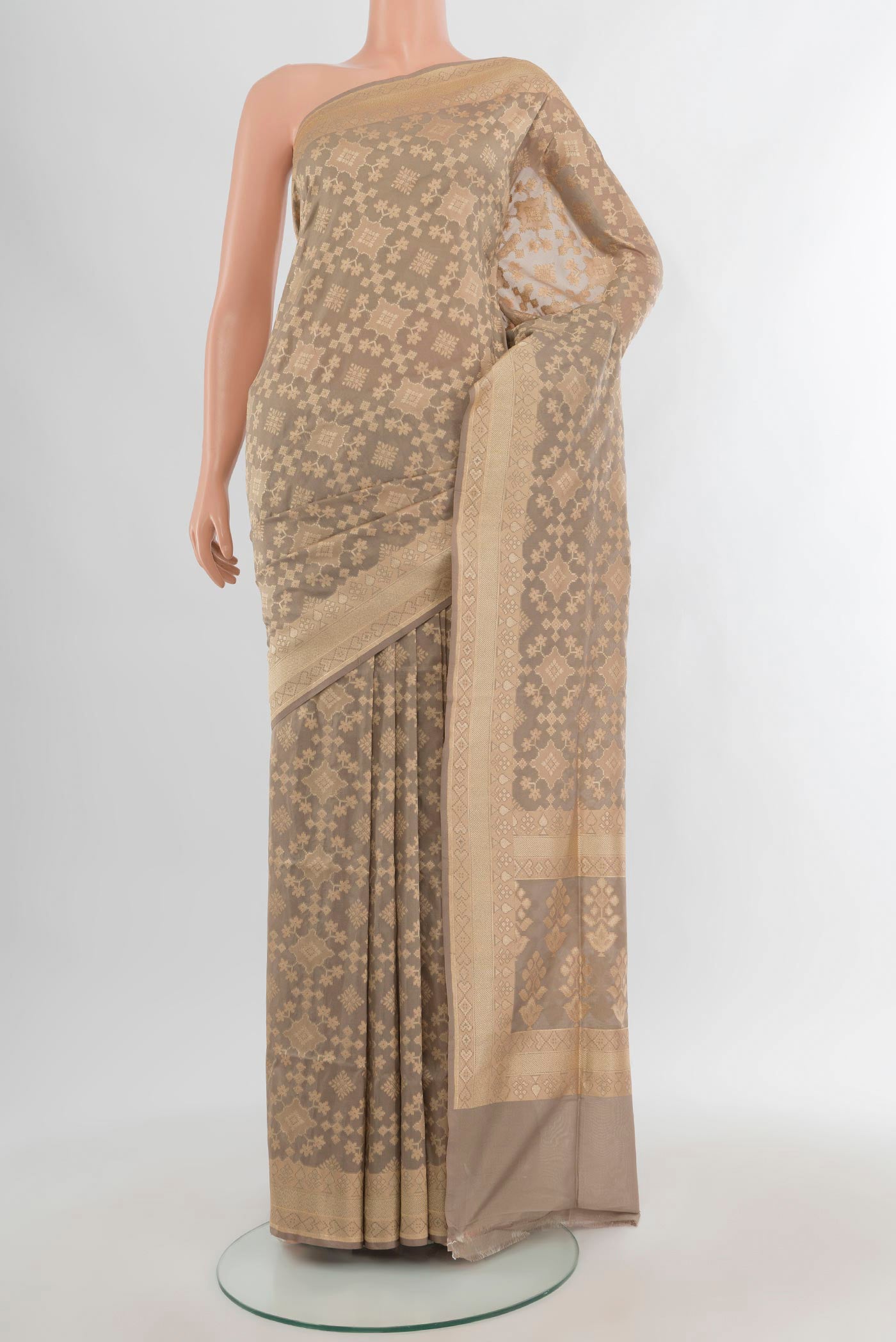 Grey Banarasi Silk Saree with Zari Butta on the body and Zari Border.  displayed on a mannequin