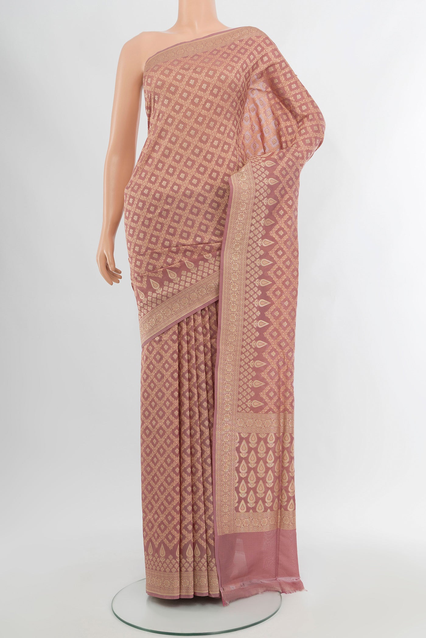 Rose Gold Banarasi Silk Saree with Zari Butta on the body and Zari Border.  displayed on a mannequin