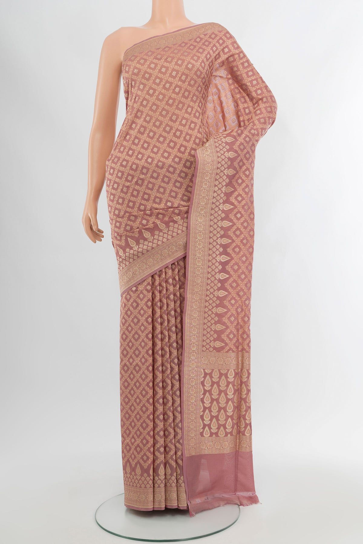 Rose Gold Banarasi Silk Saree with Zari Butta on the body and Zari Border.  displayed on a mannequin