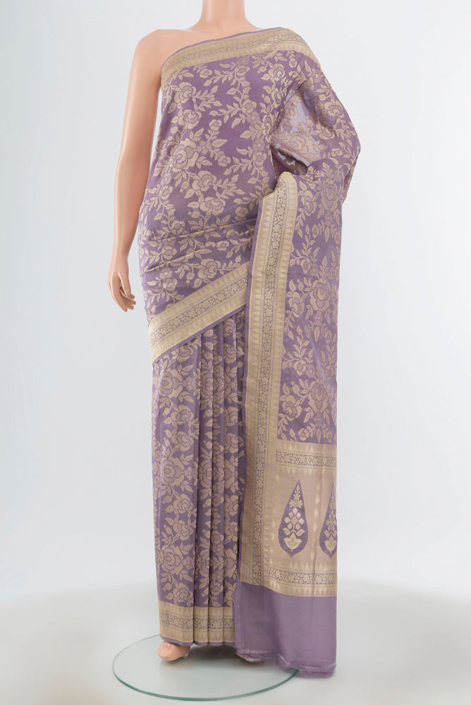 Lavender Banarasi Silk Saree with Zari Butta on the body and Silk Border.  displayed on a mannequin