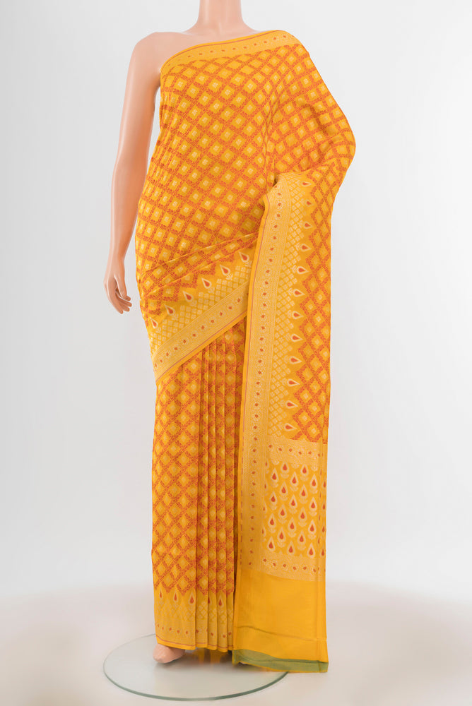 Yellow Banarasi Silk Saree with Zari Butta on the body and Silk Border.  displayed on a mannequin