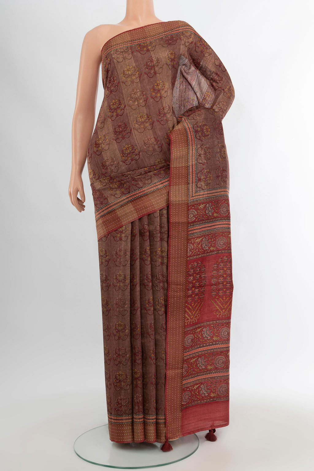 Mauve Tussar Silk Saree with Floral Print on the body and Printed Border.  displayed on a mannequin