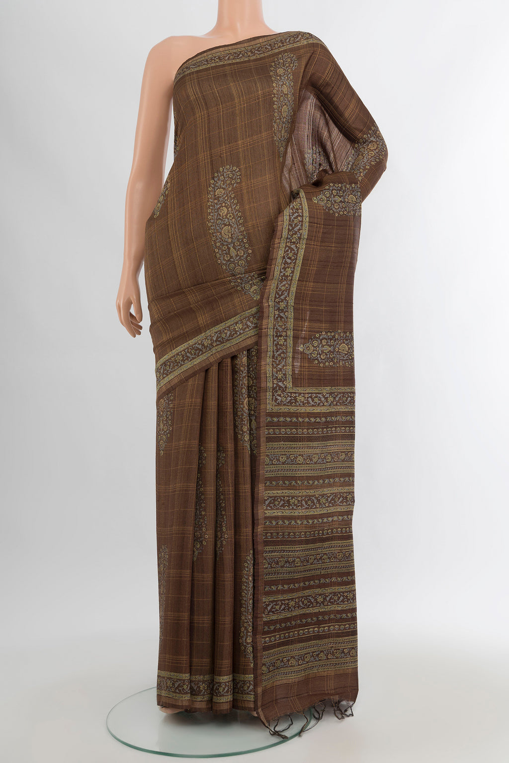 Brown Tussar Silk Saree with Floral Print on the body and Printed Border.  displayed on a mannequin