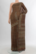 Brown Tussar Silk Saree with Floral Print on the body and Printed Border.  displayed on a mannequin