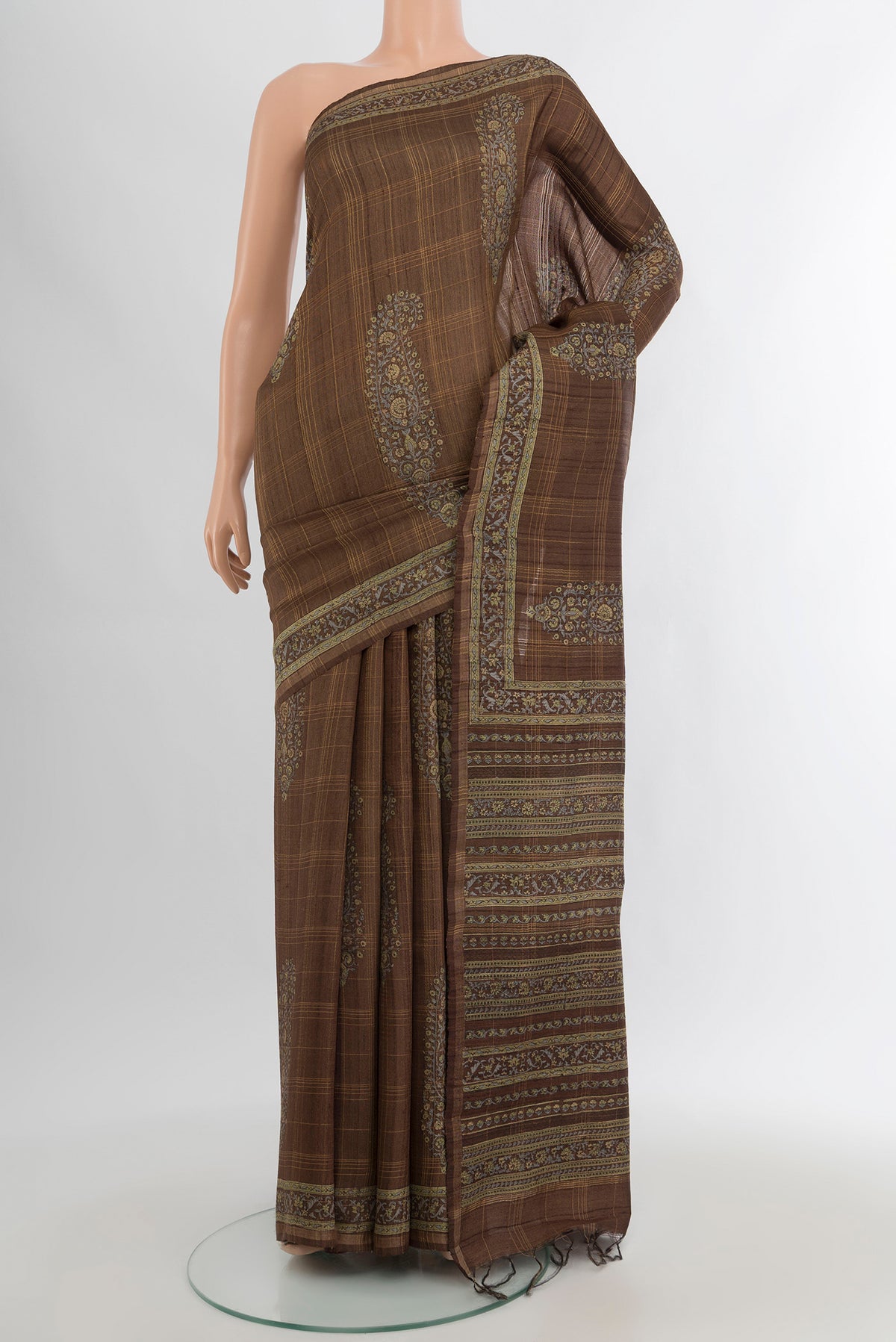 Brown Tussar Silk Saree with Floral Print on the body and Printed Border.  displayed on a mannequin