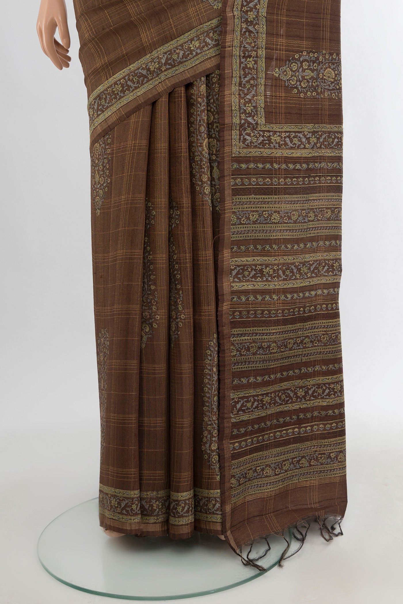 Pleats and pallu of Brown Tussar Silk Saree with Floral Print on the body and Printed Border. 