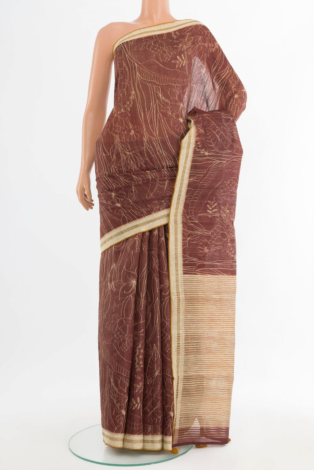 Brown Tussar Saree with Printed design on the body and Thread Border.  displayed on a mannequin