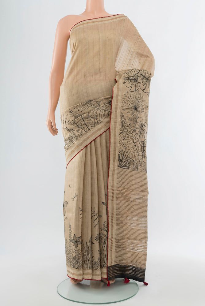 Dark Beige Tussar Silk Saree with Floral Print on the body and Silk Border.  displayed on a mannequin