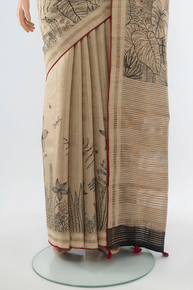 Pleats and pallu of Dark Beige Tussar Silk Saree with Floral Print on the body and Silk Border. 