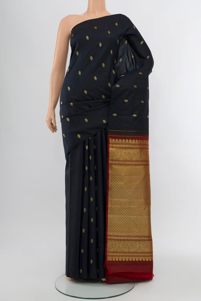 Black Kanchipuram Silk Saree with Zari Butta on the body and Silk Border.  displayed on a mannequin