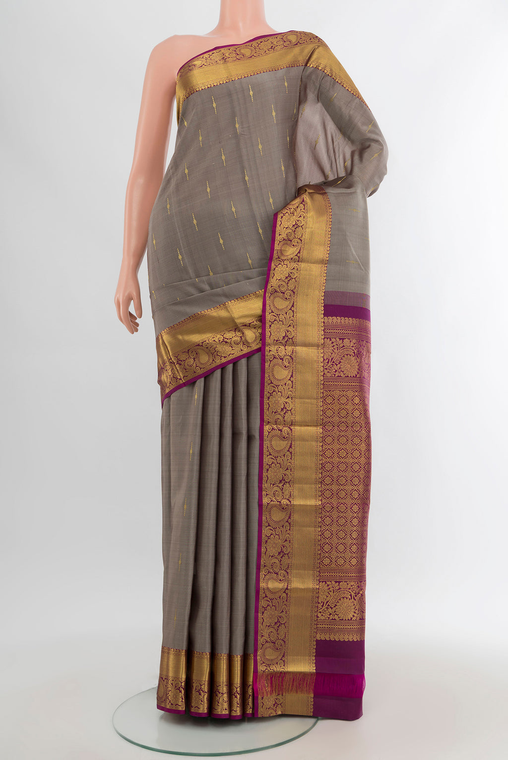 Grey Kanchipuram Silk Saree with Zari Butta on the body and Zari Border.  displayed on a mannequin