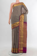 Grey Kanchipuram Silk Saree with Zari Butta on the body and Zari Border.  displayed on a mannequin