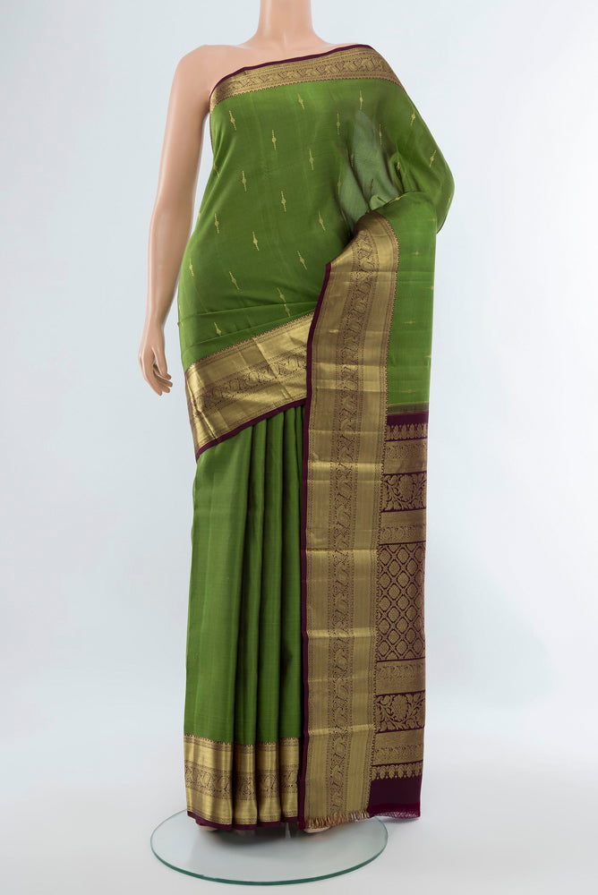 Light Green Kanchipuram Silk Saree with Zari Butta on the body and Silk Border.  displayed on a mannequin