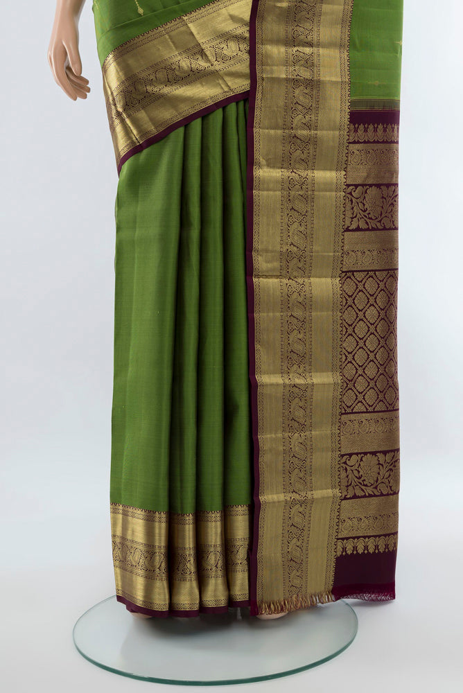 Pleats and pallu of Light Green Kanchipuram Silk Saree with Zari Butta on the body and Silk Border. 