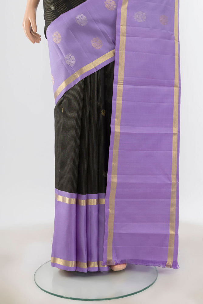Pleats and pallu of Black Kanjivaram Silk Saree with Zari Butta on the body and Silk Border. 