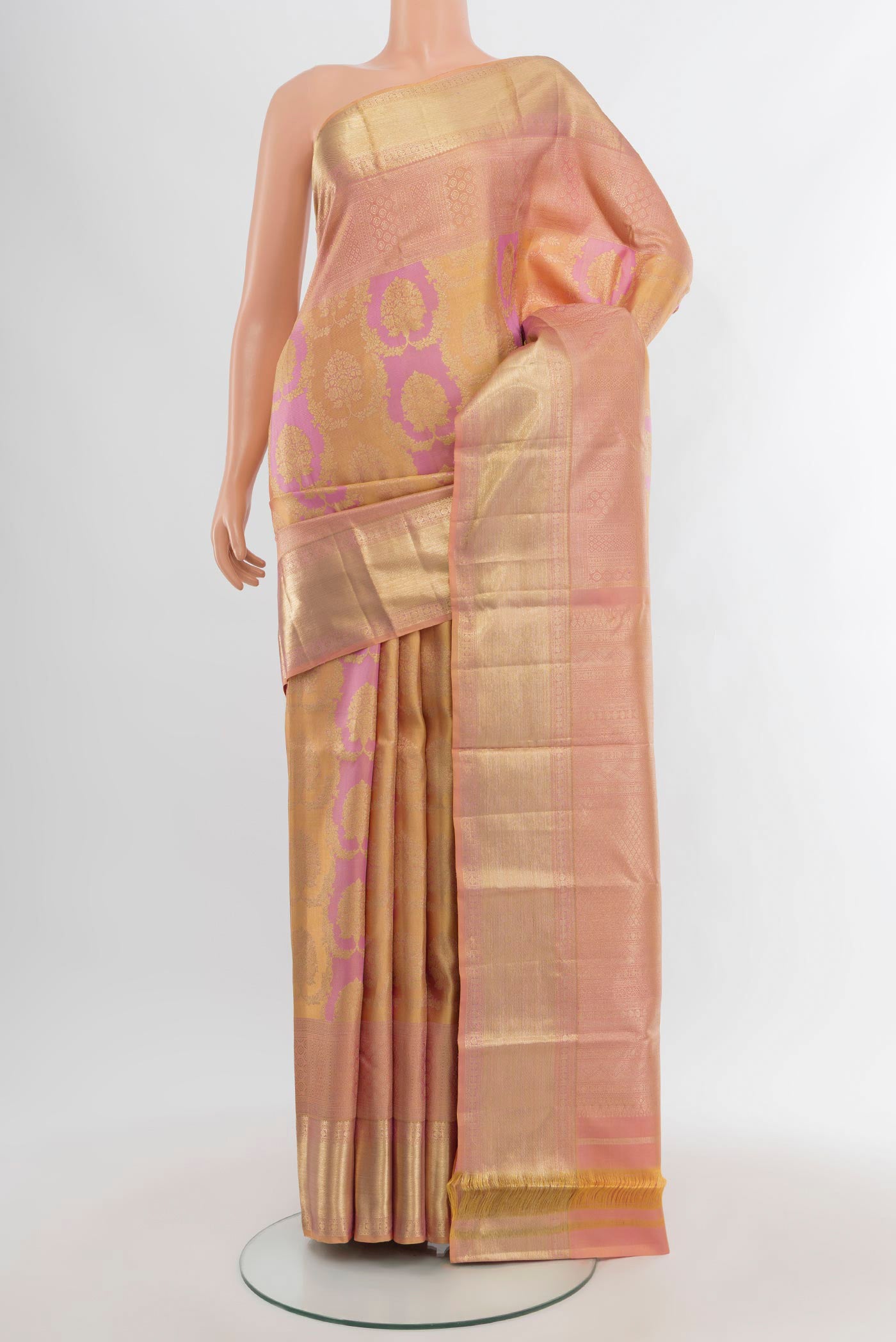Peach Kanjivaram Silk Saree with Zari Brocade on the body and Zari Border.  displayed on a mannequin