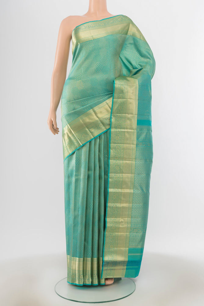 Sky Blue Kanjivaram Silk Saree with Zari Butta on the body and Silk Border.  displayed on a mannequin