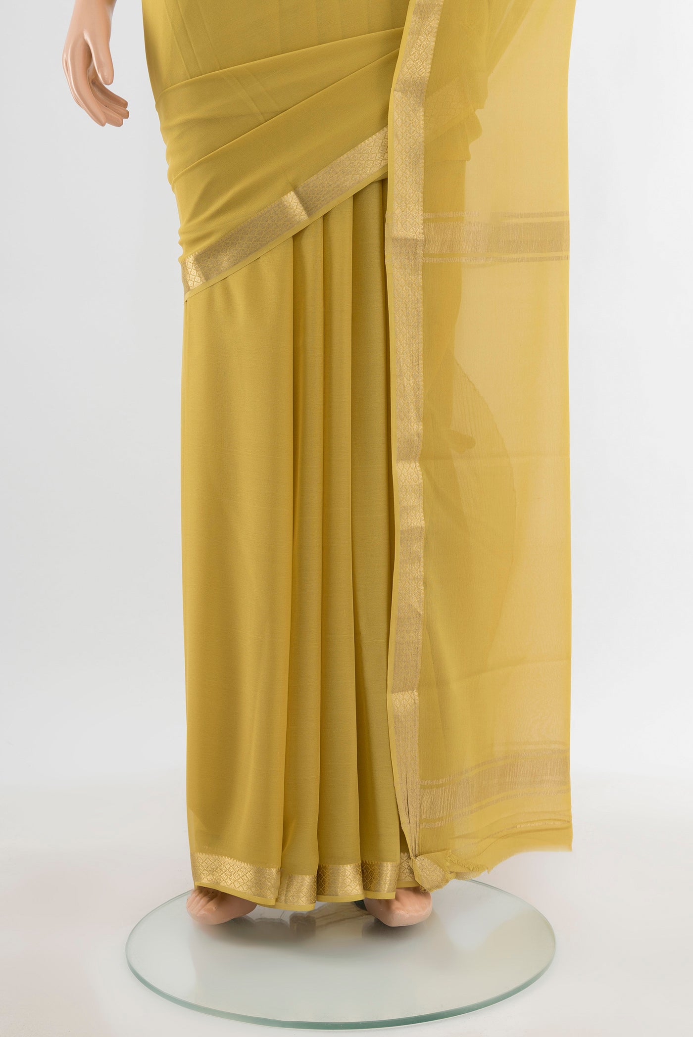 Pleats and pallu of Light Green Mysore Georgette Saree with Plain Body and Silk Border. 