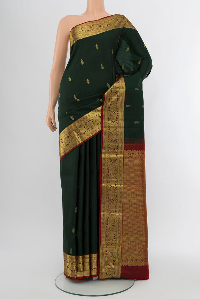 Mint Green Kanchipuram Silk Saree with Zari Butta on the body and Silk Border.  displayed on a mannequin
