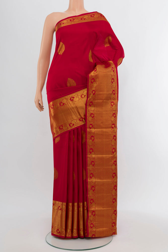 Maroon Kanchipuram Silk Saree with Zari Butta on the body and Silk Border.  displayed on a mannequin