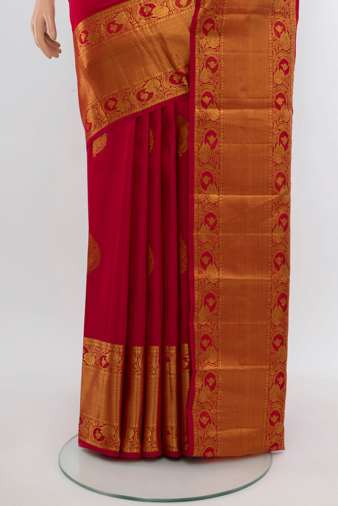 Pleats and pallu of Maroon Kanchipuram Silk Saree with Zari Butta on the body and Silk Border. 