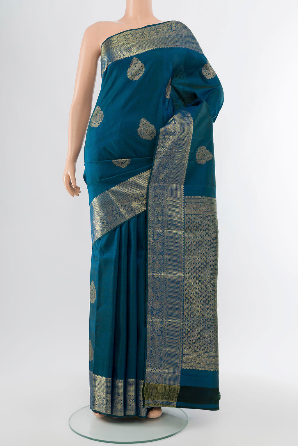 Dark Blue Kanchipuram Silk Saree with Zari Butta on the body and Silk Border.  displayed on a mannequin