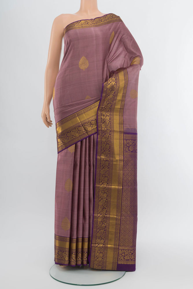 Bronze Kanchipuram Silk Saree with Zari Butta on the body and Silk Border.  displayed on a mannequin